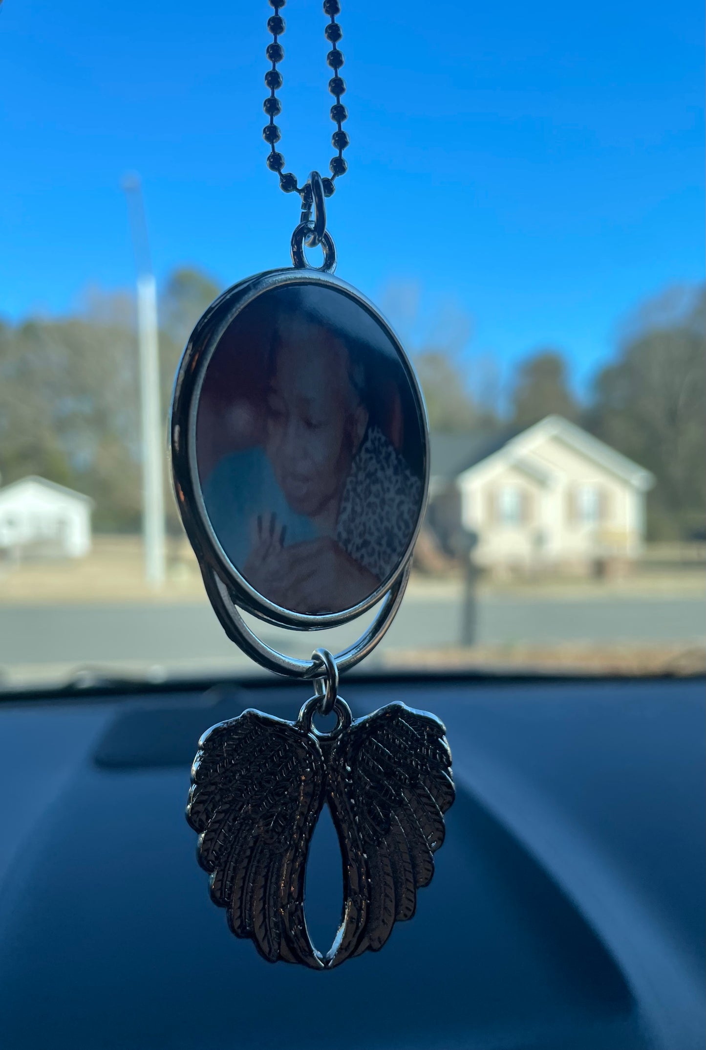 Winged rear view mirror hanger